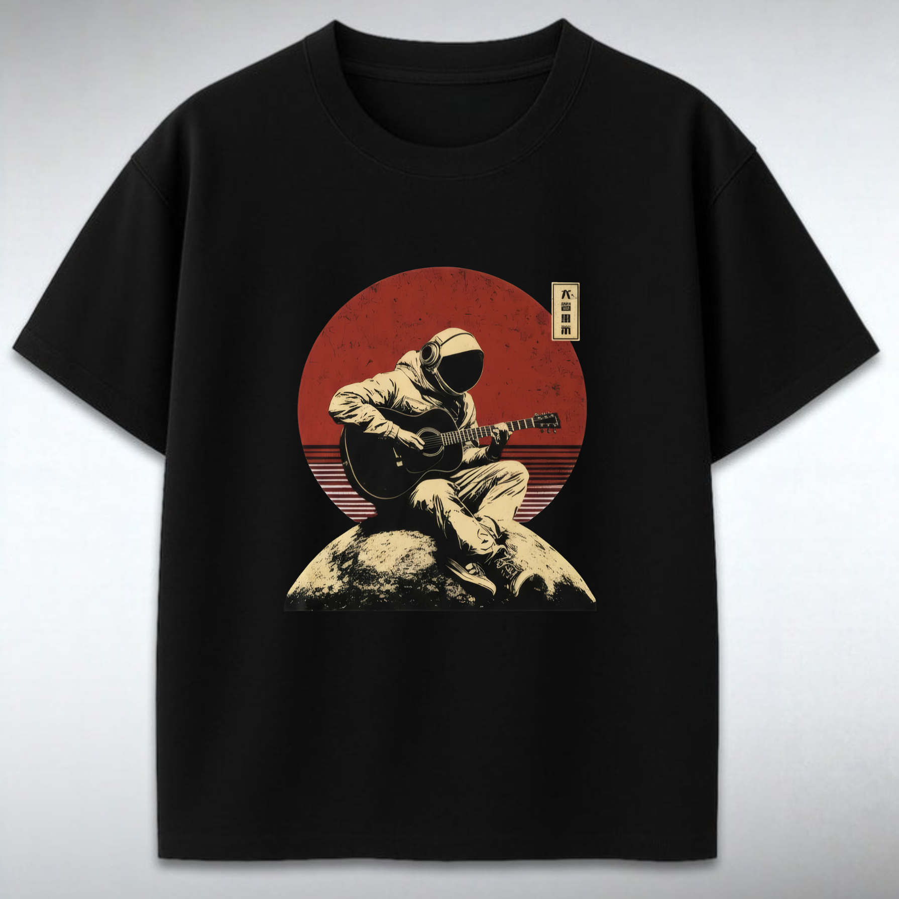 Black t-shirt with a graphic of a person playing guitar on a rock against a red sun backdrop.
