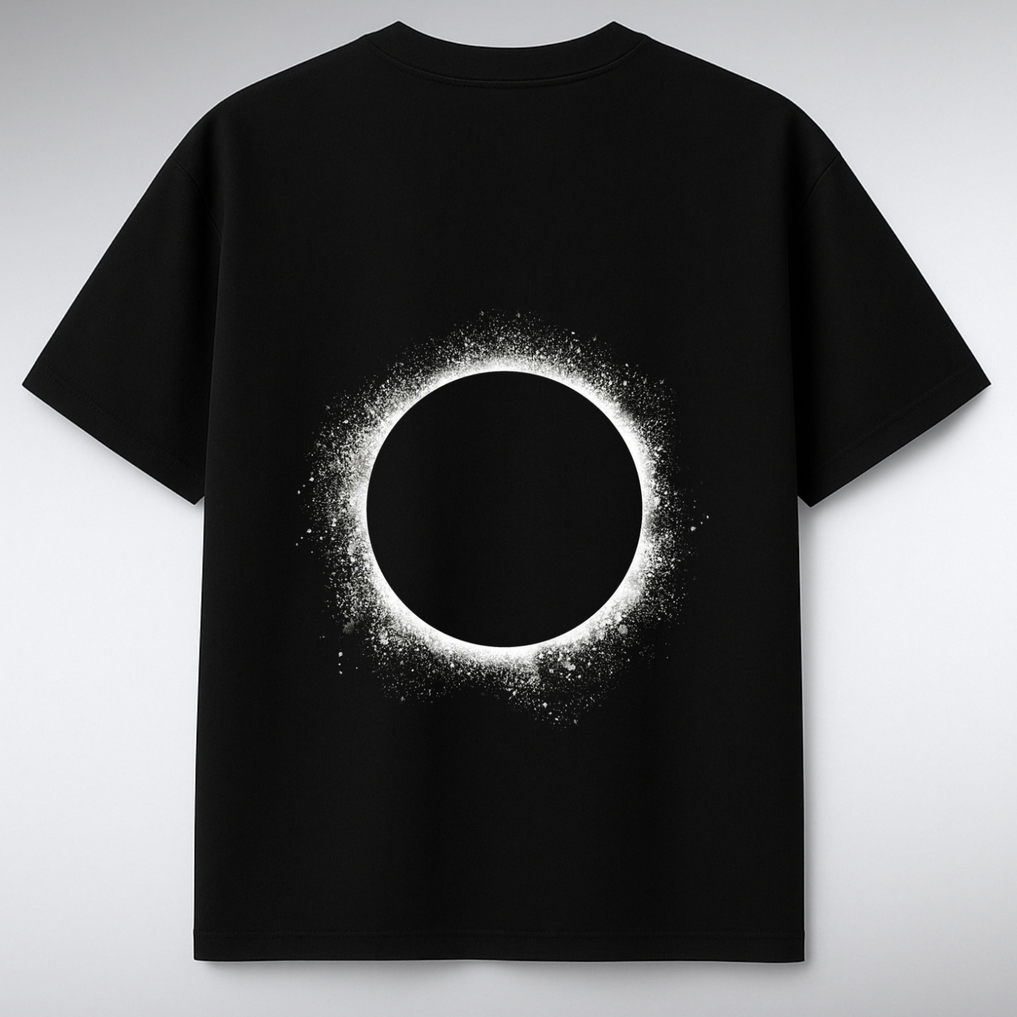 Black t-shirt with a solar eclipse design on a gray background