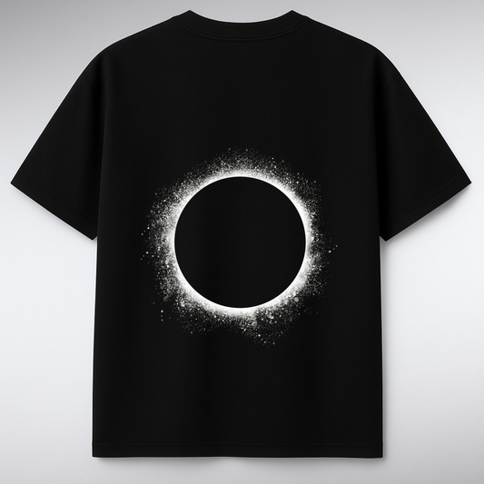 Black t-shirt with a solar eclipse design on a gray background