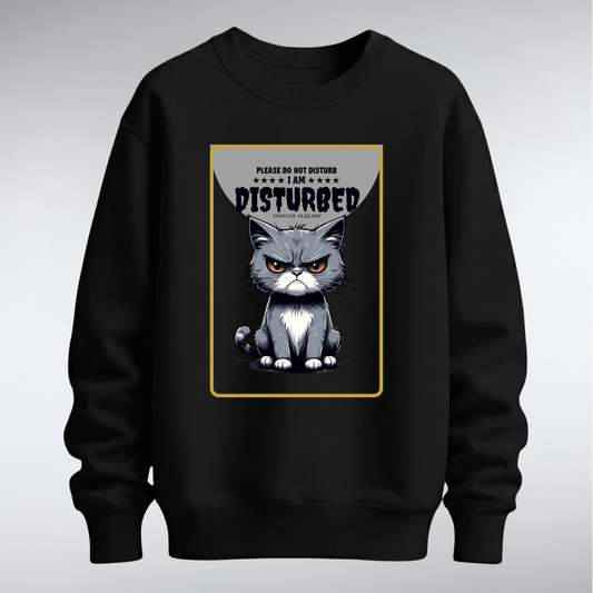 ​A premium crewneck sweatshirt featuring a centered graphic of a frowning grey cat with the text "Please Do Not Disturb." Available in multiple solid colorways with a relaxed, unisex fit.